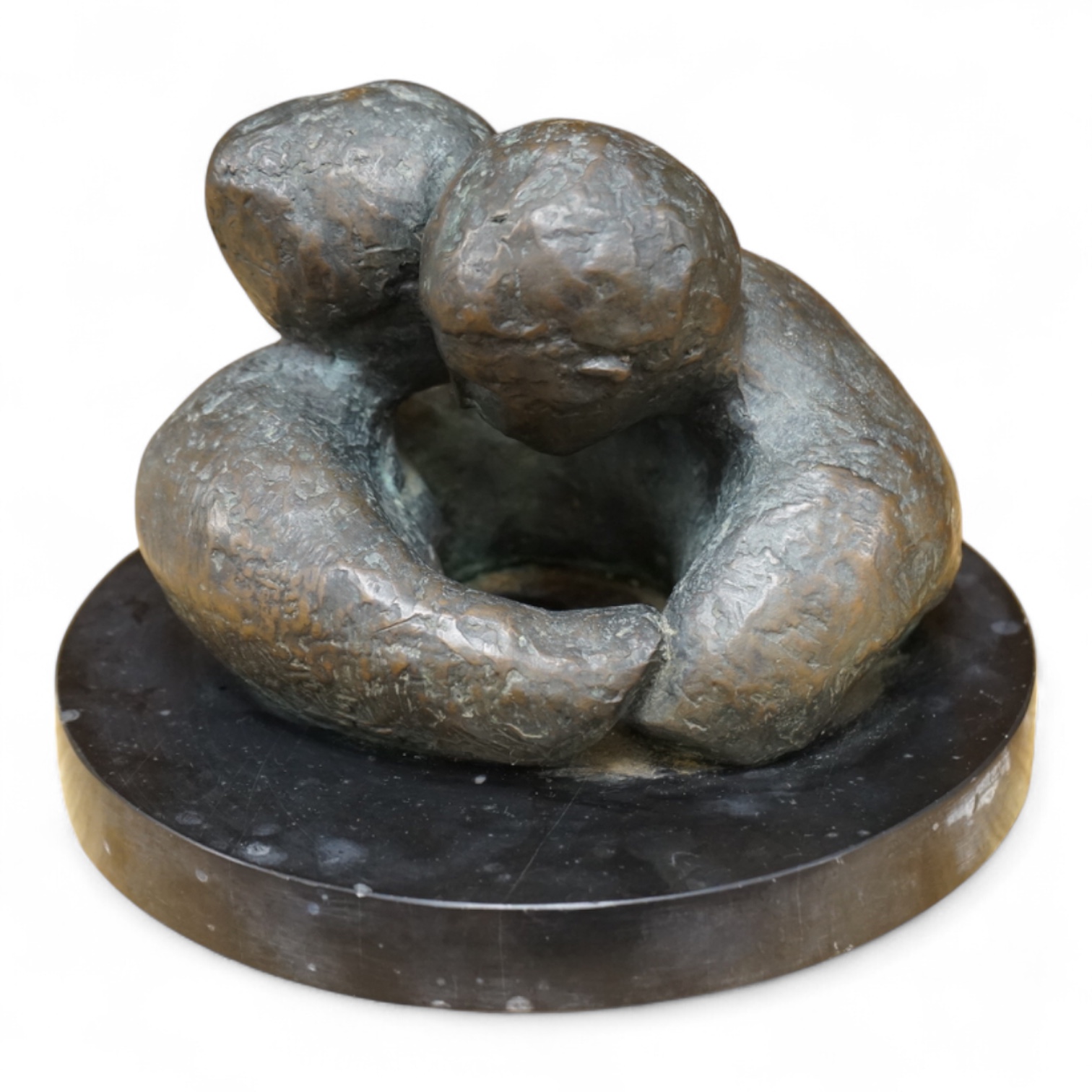 A contemporary bronze revolving sculpture of an embracing couple, unsigned, 16cm in diameter
